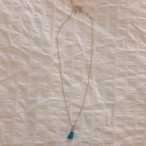 Gold necklace with blue tassel pendant